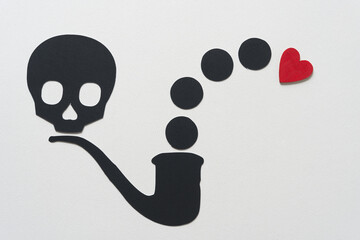 Wall Mural - black paper skull head, pipe, circles, and a wooden heart painted red on blank paper