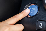 Fototapeta Mapy - Finger pushing on power button to start keyless ignition hybrid car electro engine