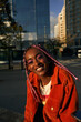 © Sheilby Macena - Portrait of young non-conforming with braids smiling in the city