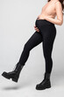 Clothes for pregnant, black pants with high waist isolated on white background, pregnancy concept.leggings for pregnant women, black tights.Special elastic band for the abdomen.
