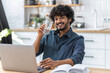 © kucherav - Healthy lifestyle. Happy successful young Asian man entrepreneur or freelancer holding a glass of clean water working at home. Recuperation concept
