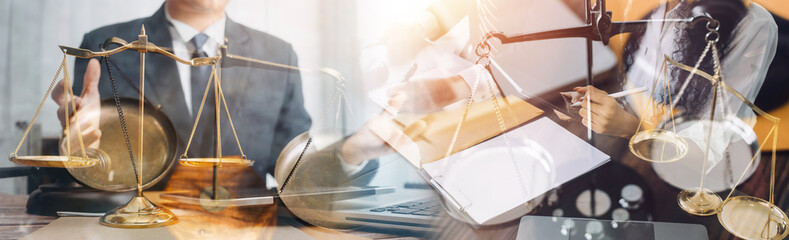 Business and lawyers discussing contract papers with brass scale on desk in office. Law, legal services, advice, justice and law concept picture with film grain effect