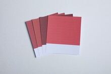 Color Sample Cards Of Red Shades On Light Background, Top View