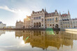 Hungarian Parliament with warm sun in the background and reflection