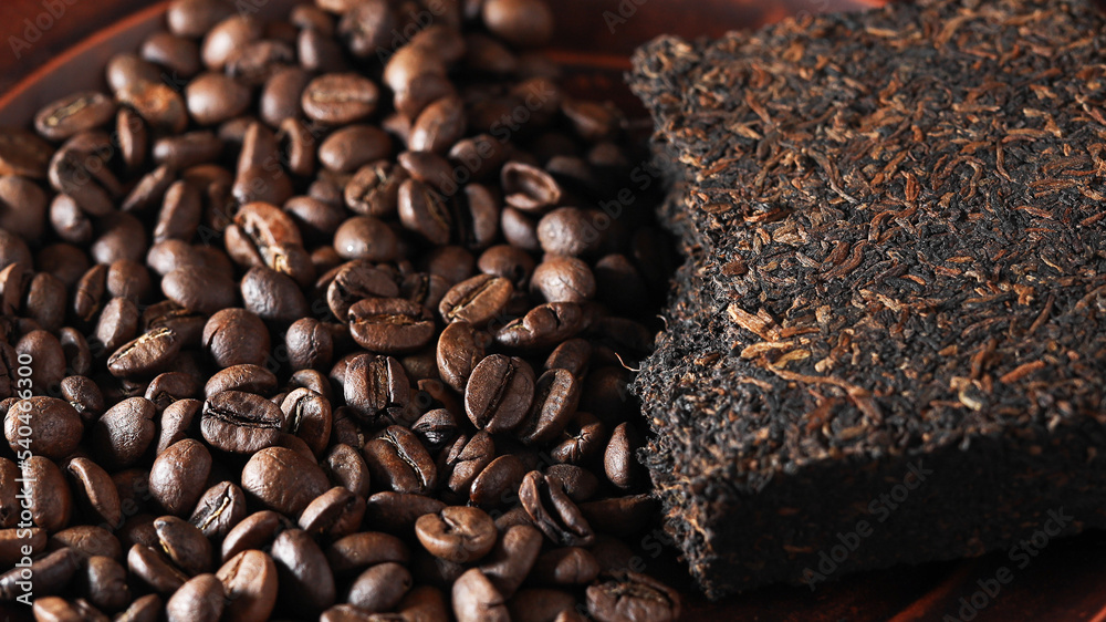 tea or coffee. coffee beans and a tile of puerh tea. puerh is a Chinese ...