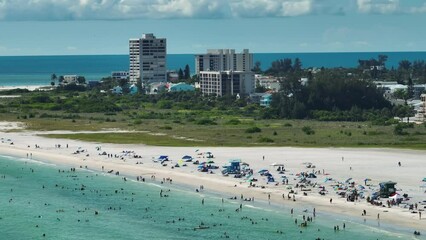 Canvas Print - View from above of Siesta Key beach with white sands full of tourists in Sarasota, USA. Many people enjoing vacation time swimming in Mexica gulf water and relaxing on warm Florida sun