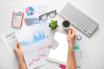 Poster - Woman working with business charts, gadgets and stationery on light background