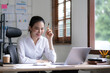 © wichayada - Asian Business woman using calculator and laptop for doing math finance on an office desk, tax, report, accounting, statistics, and analytical research concept