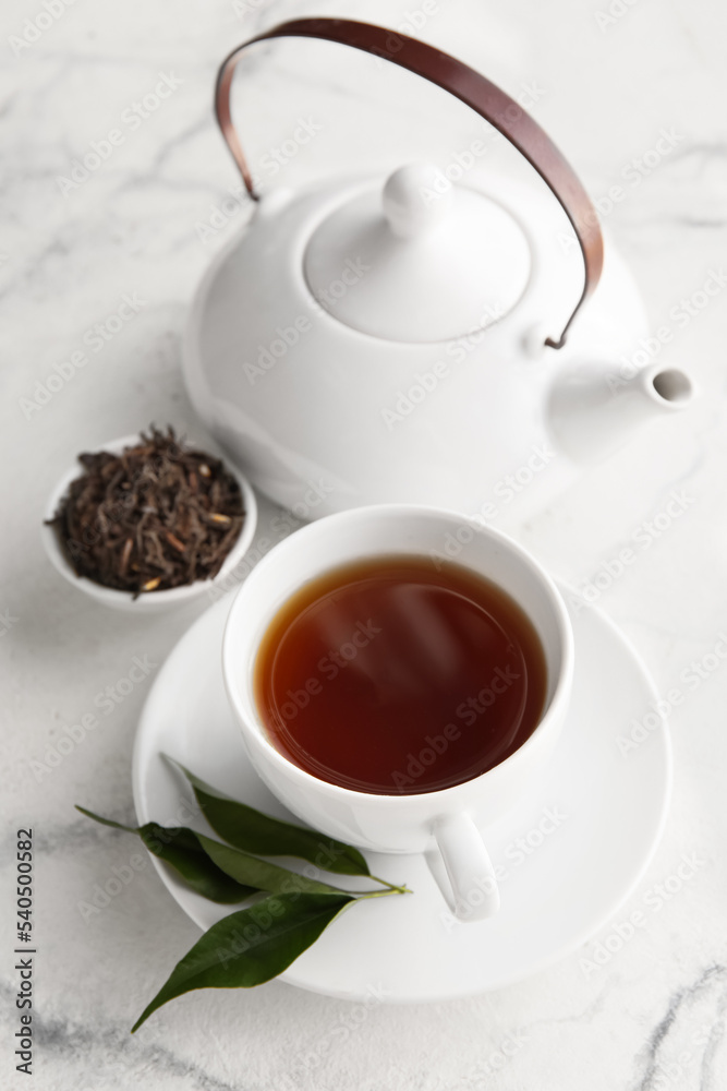 Cup of hot black tea on white background, closeup