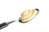 Fototapeta Tulipany - Spoon with tasty vanilla pudding on white background, closeup