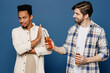 Side view young two friend teetotaler sad men in casual shirts together talk speak give bottle of beer refuse say no isolated plain dark royal navy blue background Healthy sobriety lifestyle concept