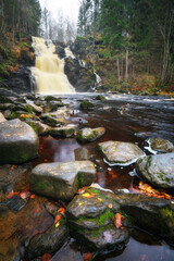 Wall Mural - Big picturesque waterfall in the autumn forest. Karelia, Russia.