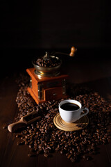 Wall Mural - Cup of coffee and beans at wood table. Homemade coffee at table