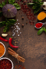 Wall Mural - Variety of spices and herbs at table background. Cooking concept and ingredients