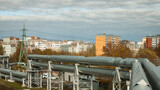 Fototapeta  - pipeline in the city, in the photo the pipeline and the city in the background