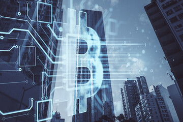 Poster - Glowing bitcoin hologram on blurry city background. Metaverse, cryptocurrency and crypto concept. Double exposure.