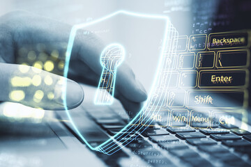 Poster - Close up of hands using laptop computer on desktop with abstract glowing secure web keyboard safety and protection hologram on blurry background. Double exposure.