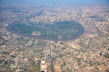 Canvas Print - Aerial view of Bangkok from the aircraft, Thailand. Chao Phraya river and main road