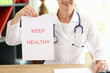 Woman therapist holding paper with lettering keep healthy