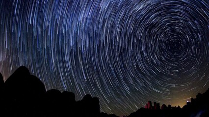 Wall Mural - Lockdown Time Lapse Shot Of Sparkling Star Trails Over Rocks At Joshua Tree National Park