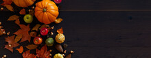 Thanksgiving Wallpaper With Autumn Leaves, Gourds And Pine Cones On A Dark Wood Surface.