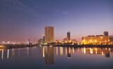 Fototapeta  - Jeddah, Saudi Arabia, sunset over the corniche and the buildings that are reflected in the sea