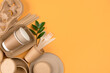 Eco-friendly tableware set over orange background with copy space - sustainable paper food packaging. Street food paper packaging, recyclable utensils, zero waste packaging concept