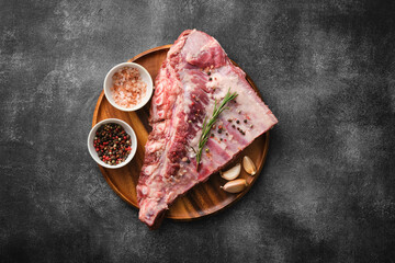 Wall Mural - Raw pork ribs with spices, salt, pepper and rosemary. Fresh pork. Pig ribs.