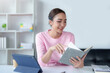 © amnaj - Attractive and beautiful Asian women are reading book and working at home their leisure and enjoying reading on vacation.