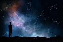 Zodiac Signs And Horoscope Concept With Black Man Silhouette On The Earth Looking At Starry Dark Sky With Constellations