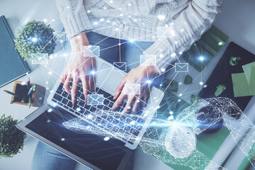 Poster - Double exposure of woman hands working on computer and envelop hologram drawing. Top View. E-mail concept.
