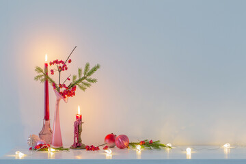 Wall Mural - pink christmas decor with burning candles in white interior