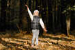 © Ruslan Ivantsov - Beautiful little girl wearing playing with dry leaves throwing them into the air