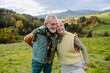 © Halfpoint - Happy senior couple walking in autumn meadow.