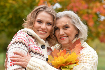 Wall Mural - Portrait of an elderly woman with her daughter in autumn.