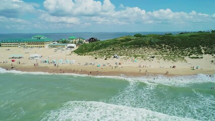 Poster - Aerial over the sandy beach with many people and azure water on a sunny summer day. Waves crashing to the shore. Relaxing calm atmosphere