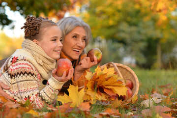 Poster - Portrait of nice grandmother of granddaughter in autumn