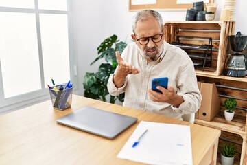 Sticker - Senior grey-haired man using smartphone working at office