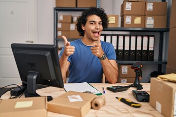 Canvas Print - Hispanic man with curly hair working at small business ecommerce pointing fingers to camera with happy and funny face. good energy and vibes.