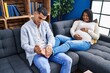 © Krakenimages.com - Young latin couple expecting baby massaging foot at home