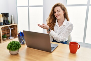 Sticker - Young caucasian woman working at the office using computer laptop pointing aside with hands open palms showing copy space, presenting advertisement smiling excited happy