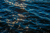 Fototapeta Na ścianę - Contrasting highlights on dark water