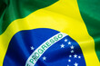 Brazilian flag shines above the golden sunset. Brazil national flag textile cloth fabric waving