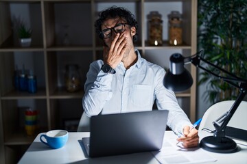 Canvas Print - Hispanic man working at the office at night bored yawning tired covering mouth with hand. restless and sleepiness.