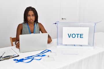 Sticker - Young african american woman working at political election sitting by ballot skeptic and nervous, frowning upset because of problem. negative person.