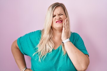 Poster - Caucasian plus size woman standing over pink background touching mouth with hand with painful expression because of toothache or dental illness on teeth. dentist