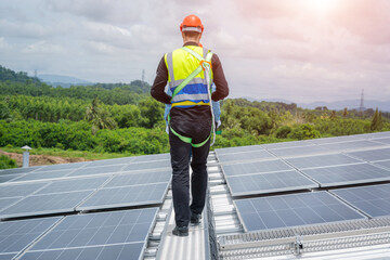 Poster - Professional worker installing and checking solar panels on the roof of a factory,Innovative solution for energy solving. Use renewable resources. Green energy.