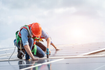 Aufkleber - Solar panel technician with drill installing solar panels on roof factory.
