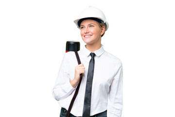 Young architect caucasian woman with helmet and holding blueprints over isolated background happy and smiling