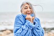 © Krakenimages.com - Middle age grey-haired woman smiling confident standing at seaside